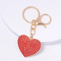 Close-up of heart-shaped keychain with red rhinestones and golden lobster clasp - Full Rhinestone Red Heart