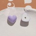 Close-up of heart-shaped purple and white resin beads with a flat back and center hole - Purple Heart