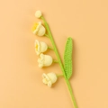 Close-up of handmade crochet Lily of the Valley with soft yellow bells and green stems - Finished Product - Four-headed Lily Of The Valley Stem - Yellow