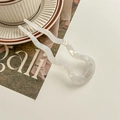 Detail of white U-shaped wavy hair pin with a sparkling rhinestone on a magazine - Pearl White