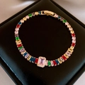 Detail of tennis bracelet with colorful rectangular gemstones and gold-plated clasp - Colorful