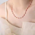Pink evil eye bead necklace on golden titanium steel chain worn by a female model - Pink Necklace