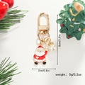 Detailed view of Santa Claus Christmas keychain with white pearl accent and gold ring - Waving Santa