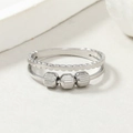 Detailed macro of silver fidget ring with three rotating beads and wave textured band - Double Layer Steel Color Striped Beads