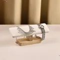 White leather jewelry display stand with solid wood base holding watch and necklace - 1-Tier Solid Wood Bracelet Stand-White PU