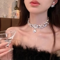 Close-up of sparkling rhinestone bow necklace with pearl pendant on a model neck - 7# Necklace - Regular - Silver
