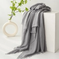 Minimalist grey cotton linen scarf with fringe edges draped over a white cube - Silver Gray