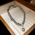 Macro shot of dark grey pearl necklace with a drop-shaped diamond pendant in a wooden box - 46# Grey 8mm Pearl Teardrop Necklace