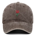 Close-up of a rose embroidery on a vintage washed cotton baseball cap with fabric texture - Coffee