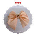 Champagne gold satin bow hair accessory featuring a central square brown rhinestone - Off White
