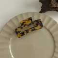 Detailed view of a dark leopard print acetate hair claw clip on a minimalist ceramic tray - Medium Square Claw