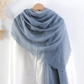 Blue pleated cotton linen scarf with frayed edges displayed on a wooden hanger - Blue
