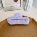 Plush light purple faux fur shark hair claw clip in an elegant minimalist home setting - Purple