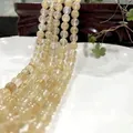 Natural yellow tiger eye beads for jewelry making displayed on a white ceramic plate - 6mm / Approx 63pcs / Smoky Watermelon Quartz
