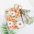 Floral print coin purse detail with gold metal clasp and decorative tassel accent - Beige Floral