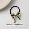 Minimalist elastic hair tie with a polished gold metallic bow charm for women - 17# Bowknot Gold