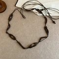 Detail view of ethnic wood beaded belt with dark resin and acrylic accents - 14# Long Wood Bead Style (Coffee)