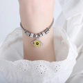 Silver beaded evil eye bracelet featuring a yellow charm and sparkling accents - E453-Steel Color Bracelet