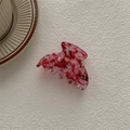 Close-up of a small French style hair claw with vintage red and white floral texture - Ghost Hand Claw / Blood Red