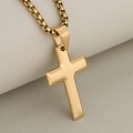 Collar minimalista con cruz de acero inoxidable dorado y cadena de caja en fondo suave - Dorado