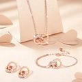 Conjunto de joyas en oro rosa con dobles anillos entrelazados, números romanos y circón - Oro rosa
