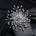 Detail of handmade snowflake brooch with grey pearls and golden wire on black velvet - Grey Pearl Style (Style 6)