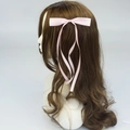 Pink satin bow hair clip with double long ribbons on brown wavy hair for women - Pink
