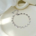 Silver tone heart link bracelet with detailed radial engravings and lobster clasp closure - Silver Bracelet