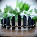 Detail of handcrafted black crystal crown with intricate silver wire weaving on wood - Obsidian Gold Wire Gold Flat Headband