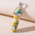 Macro shot of a hexagonal stone pendant with a yellow base and colorful terrazzo flecks - Mixed Color Stone