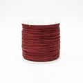 Macro shot of 0.8mm burgundy jewelry cord wound on a spool for DIY braiding crafts - Color 192 Dark Red