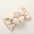 Detailed close-up of beige knitted baby headband with fabric flower and pink center - Dirty White