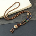 Ethnic style necklace with brown wooden beads and a white pattern pendant - Oval Vajra Bodhi