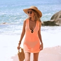 Detail of orange crochet beach cover-up featuring deep V-neck and metal ring buckle - S / Orange Pink