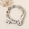Detail of leopard print baby headband featuring a soft bow and elastic cotton texture - Leopard Print