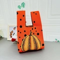 Orange knitted pumpkin knot bag with black polka dots and woven autumn pattern - Pumpkin Orange