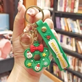 Christmas wreath keychain with Santa and snowman motifs on a green silicone strap - Christmas Tree Flower (Gold Keychain)