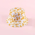 Reversible bucket hat with yellow cow print pattern on a light pink background - Yellow
