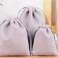 Three sizes of light gray velvet jewelry pouches with drawstrings on a wood surface - 10*12cm Grey Velvet Pouch-9*9*1.6cm