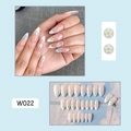 Close-up of nude pink French tip press-on nails with white daisies and light blue patterns - W022 Blue Small Flowers
