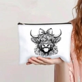 Close-up of white canvas makeup bag featuring a highland cow print and black zipper - Black and White Line Art Highland Cow (139-3)