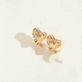 Detailed macro view showing the unique lava texture on golden heart-shaped hoop earrings - Gold Heart Style