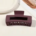 Close-up of a large matte dark purple hair claw clip with a hollow rectangular design - 10.5cm Rectangular - Matte Deep Bean Paste