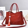 Elegant red pleated handbag with golden hardware and a white lotus flower tassel charm - Burgundy