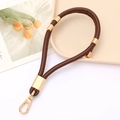Detail of adjustable brown leather strap with gold metal rings and lobster clasp - Coffee
