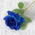 Single deep blue artificial rose with velvet texture on a white knit background - Elsa Blue