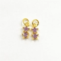 Detailed view of two purple star-shaped charms with gold-plated metal and zircon accents - Purple