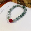 Macro detail of green phantom quartz bracelet with a red strawberry quartz and gold beads - Exquisite Gift Box / Strawberry Quartz & Green Phantom Crystal (Wealth Charm)