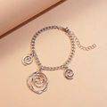 Detail of silver chain bracelet featuring spiral rose charms and adjustable lobster clasp - Bracelet / Silver