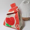 Knitted beige handbag with red apple flower pattern and unique single twist handle - Heart Flower Orange